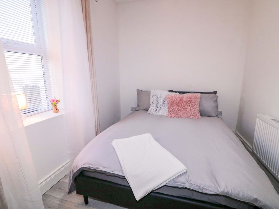 A bedroom with a bed, pillows, and a lamp at San Antonio, Dungloe, County Donegal