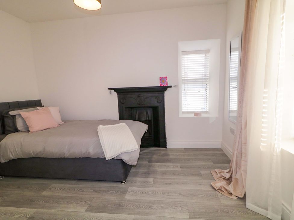 A bedroom with a bed and a fireplace at San Antonio, Dungloe, County Donegal