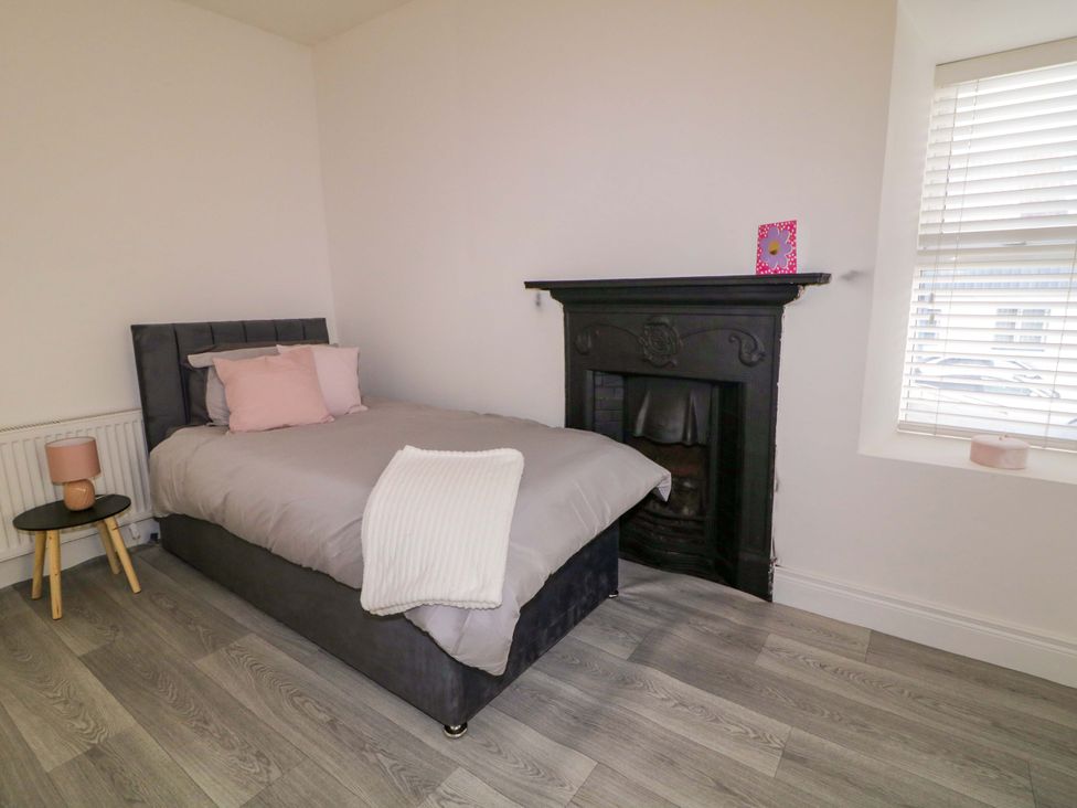 A bedroom with a bed and fireplace at San Antonio, Dungloe, County Donegal