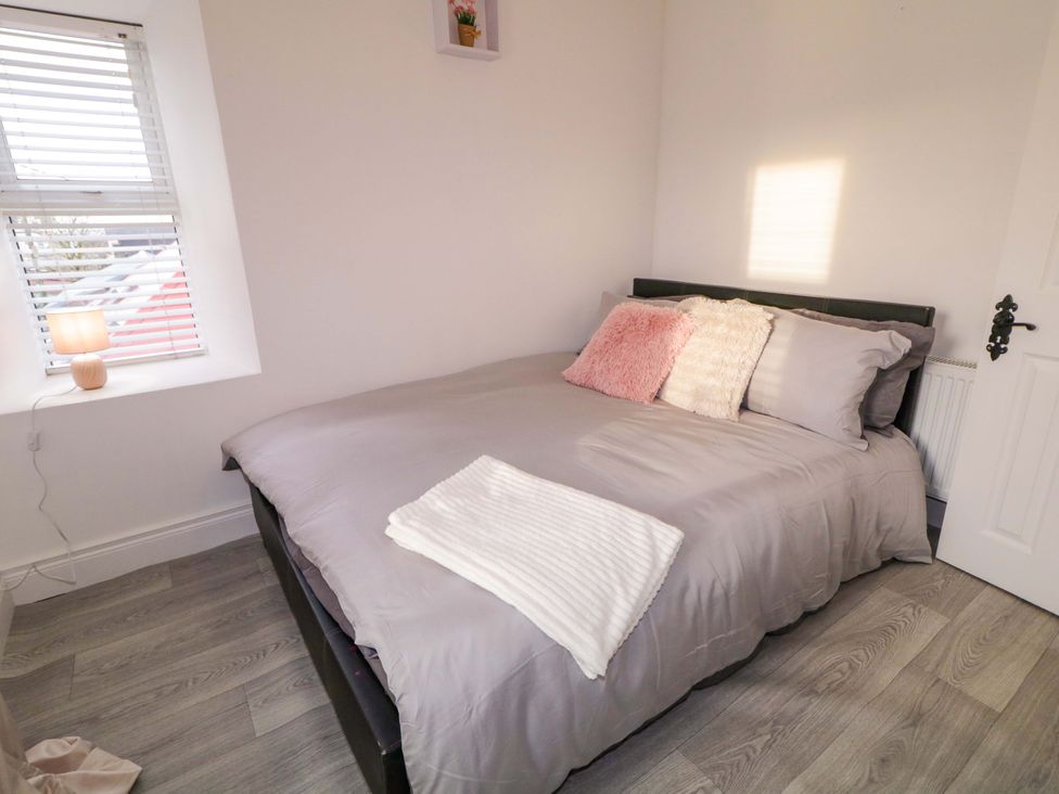 A bedroom with a bed and lamp at San Antonio, Dungloe, County Donegal