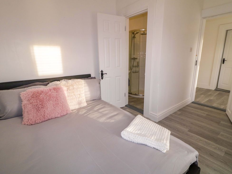 A bedroom with a bed and a shower door at San Antonio in Dungloe, County Donegal