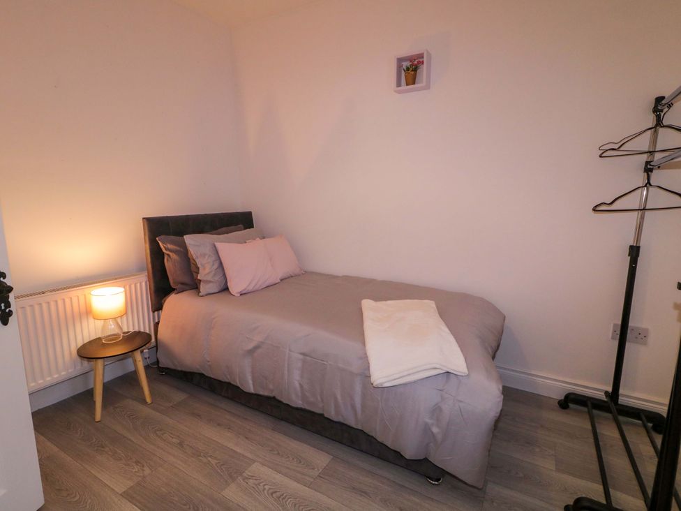 A bedroom with a bed and side table at San Antonio in Dungloe, County Donegal