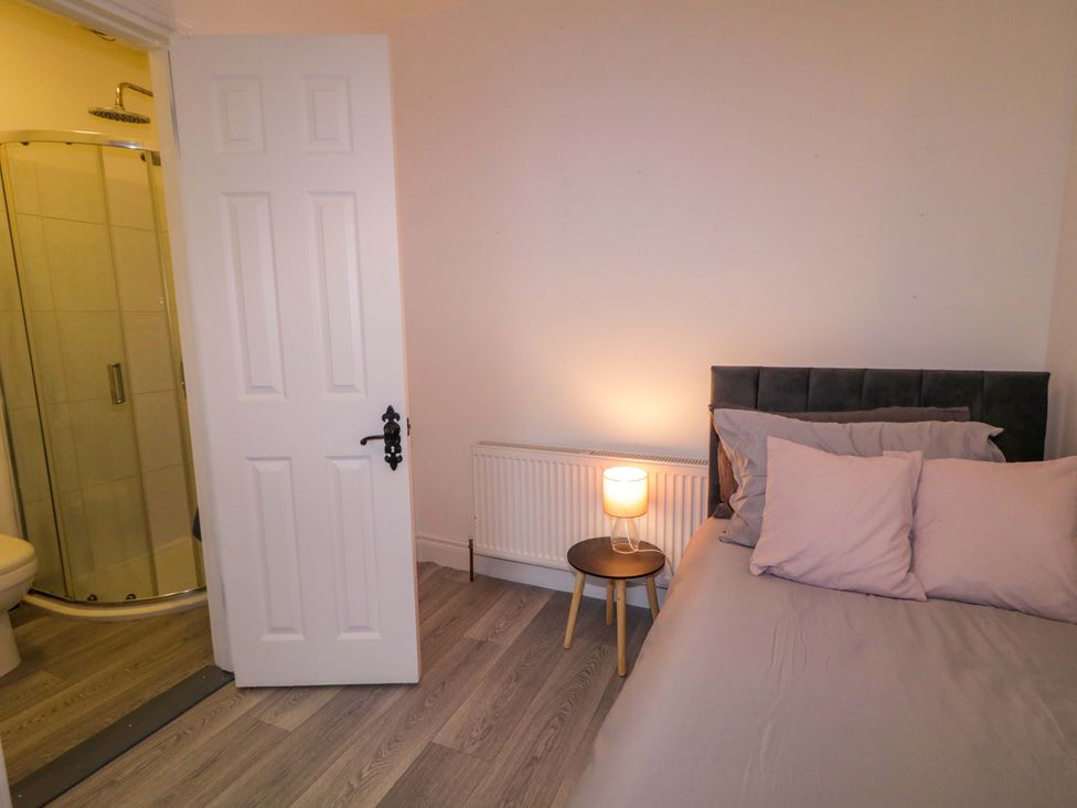 A bedroom with a bed and bathroom access at San Antonio, Dungloe, County Donegal