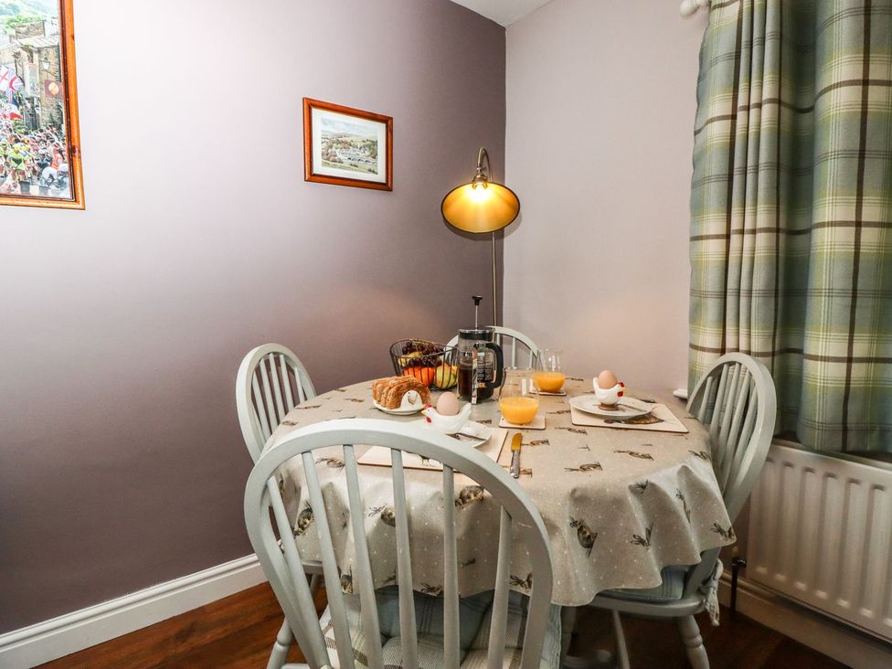 A dining room with a table set for breakfast at Baywood Cottage in Keighley