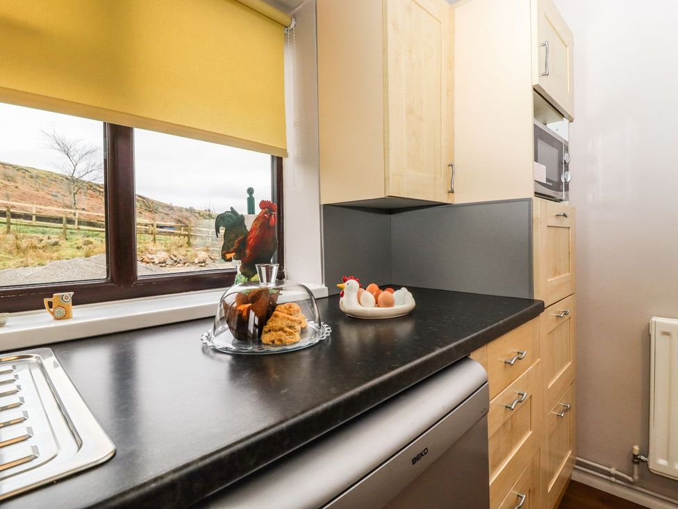 A kitchen with a window and sink at Baywood Cottage in Keighley
