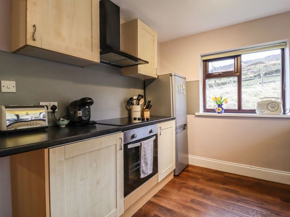 A kitchen with appliances and utensils at Baywood Cottage in Keighley