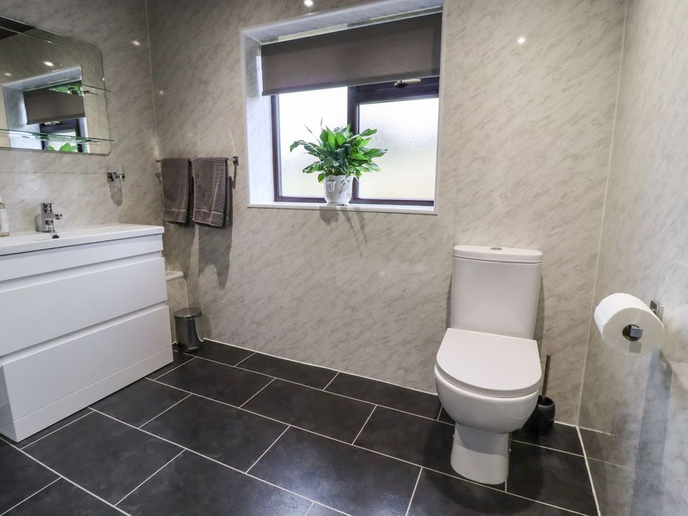 A bathroom with a sink and toilet at Baywood Cottage in Keighley