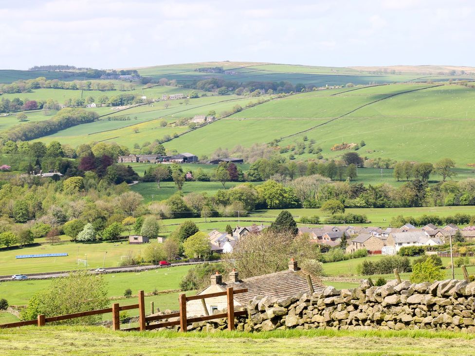 A landscape view with fields and houses at Baywood Cottage in Keighley
