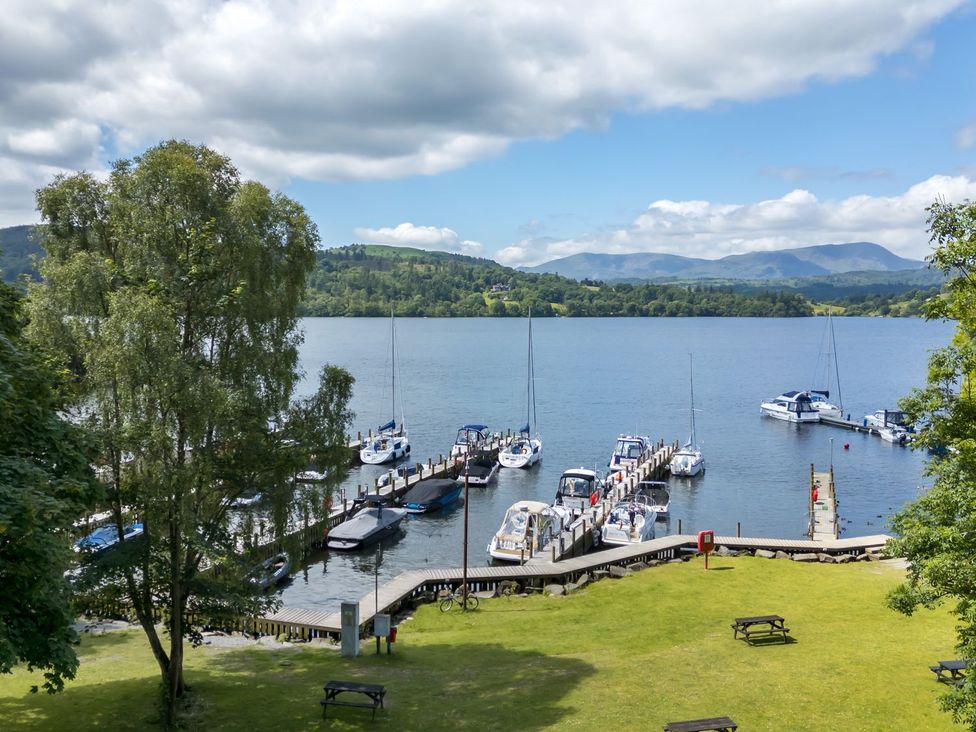 A view of boats docked at the water at Kingfisher Lodge in Windermere