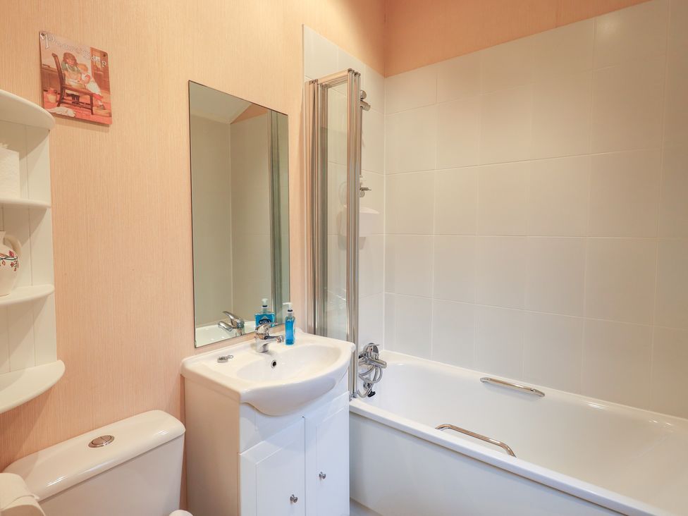 A bathroom with a bathtub and sink at Kingfisher Lodge, Grasmere 33, White Cross Bay near Windermere
