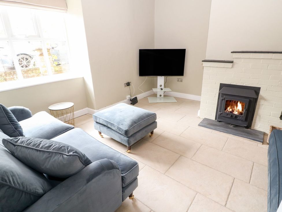 A living room with a sofa and television at The Old Bakery in Banbury