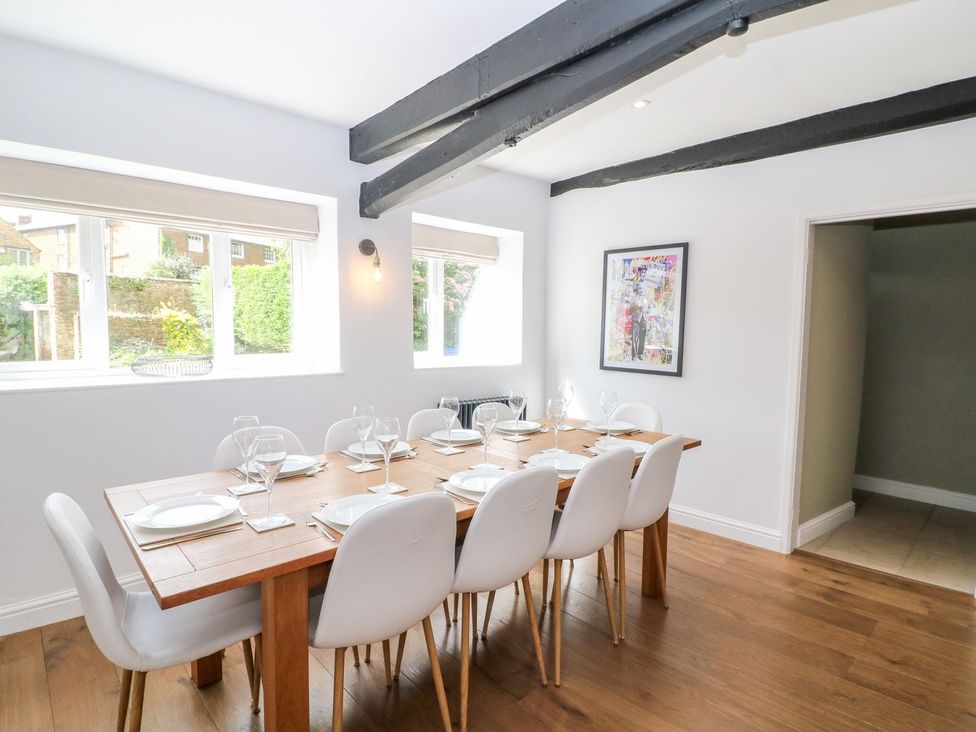 A dining room with a wooden table and chairs at The Old Bakery in Banbury