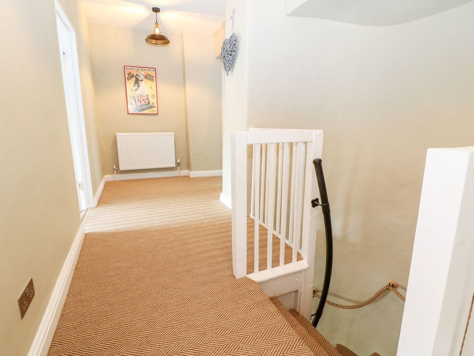 A hallway with a staircase and radiator at The Old Bakery in Banbury