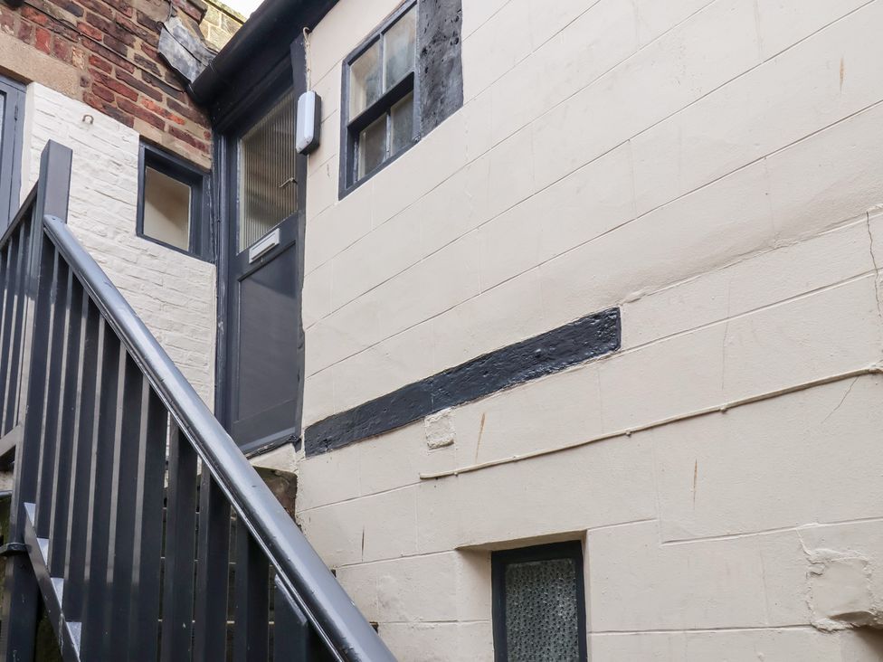 An exterior view of stairs leading to a door at Stowaway Cottage in Whitby