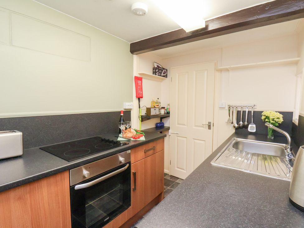 A kitchen with a sink and appliances at Stowaway Cottage in Whitby