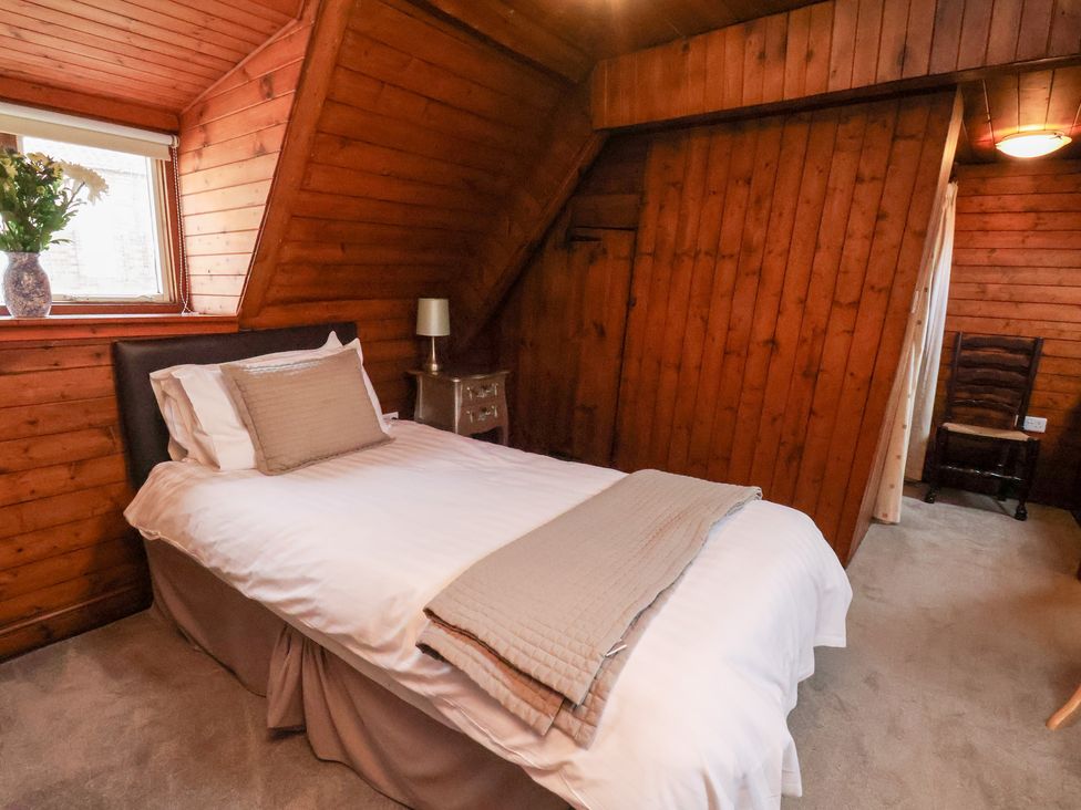 A bedroom with a bed and a window at Stowaway Cottage in Whitby