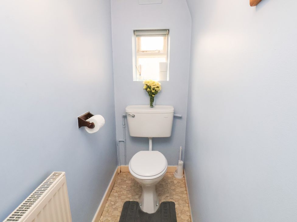 A bathroom with a toilet and sink at Stowaway Cottage in Whitby