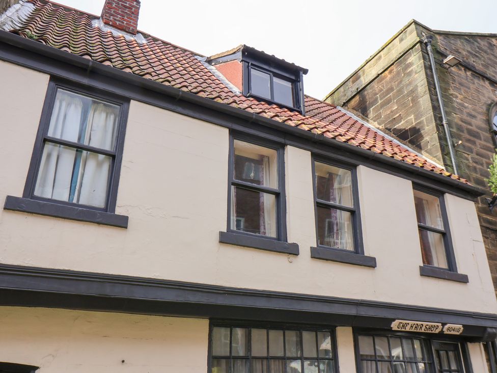 An exterior view of a building with windows and a chimney at Stowaway Cottage in Whitby