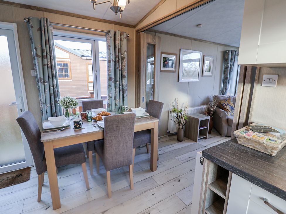A dining room with a table set for breakfast at Fern Lodge in Stonham Aspal