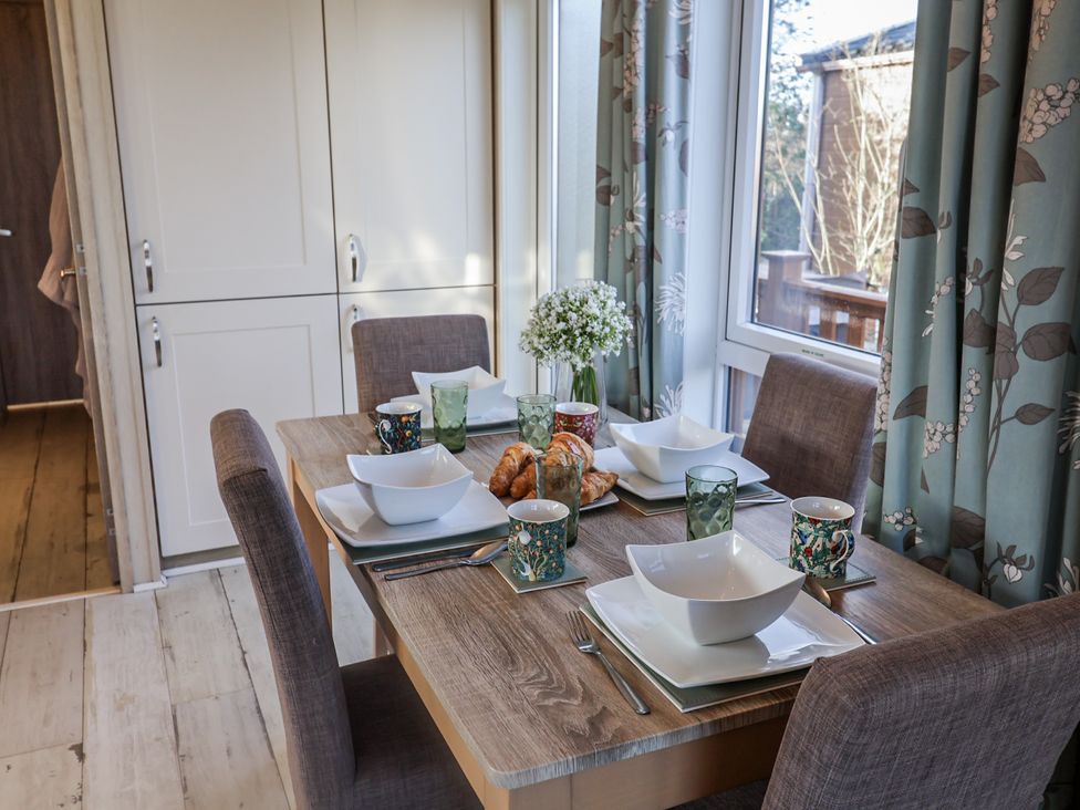 A dining room with a table set for breakfast at Fern Lodge in Stonham Aspal