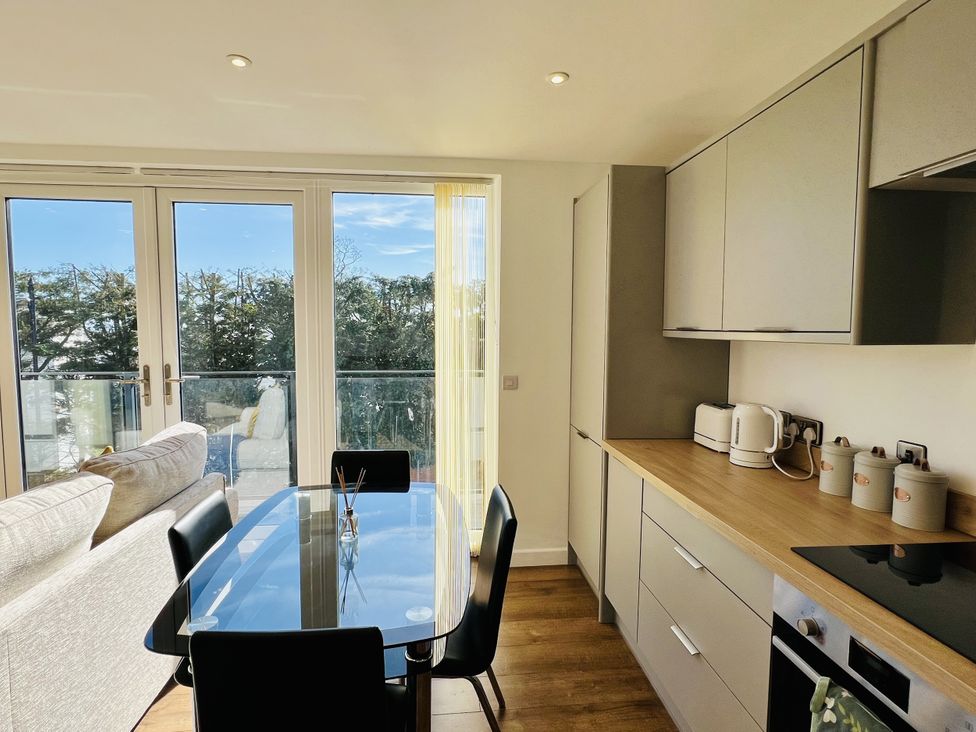 A kitchen with a dining table and chairs at 2A Hamilton Road in Felixstowe