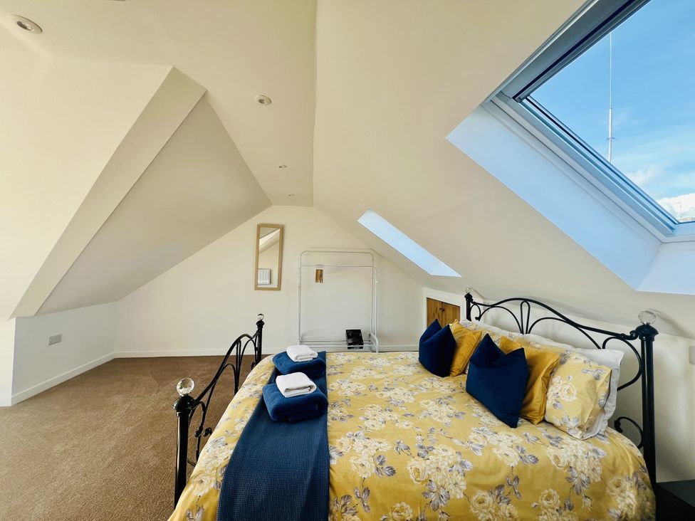 A bedroom with a bed and a window at 2A Hamilton Road Felixstowe