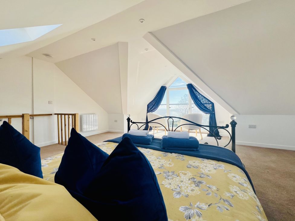 A bedroom with a bed and window at 2A Hamilton Road in Felixstowe