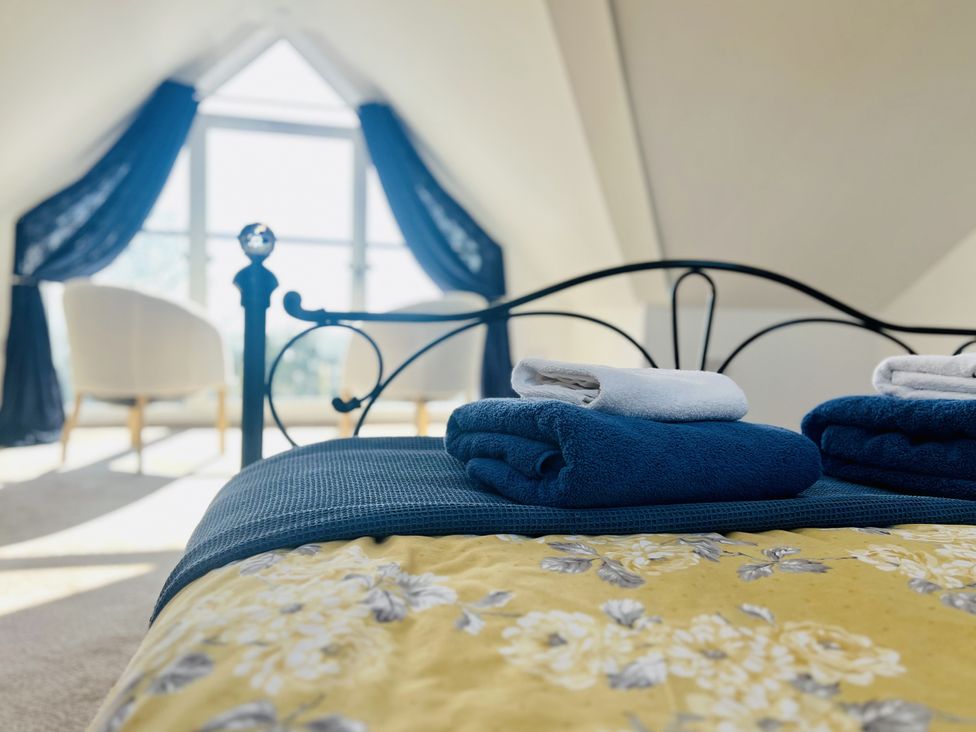 A bedroom with a bed and towels on it at 2A Hamilton Road Felixstowe