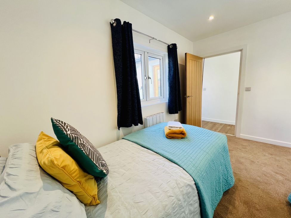 A bedroom with a bed, pillows, and a window at 2A Hamilton Road in Felixstowe
