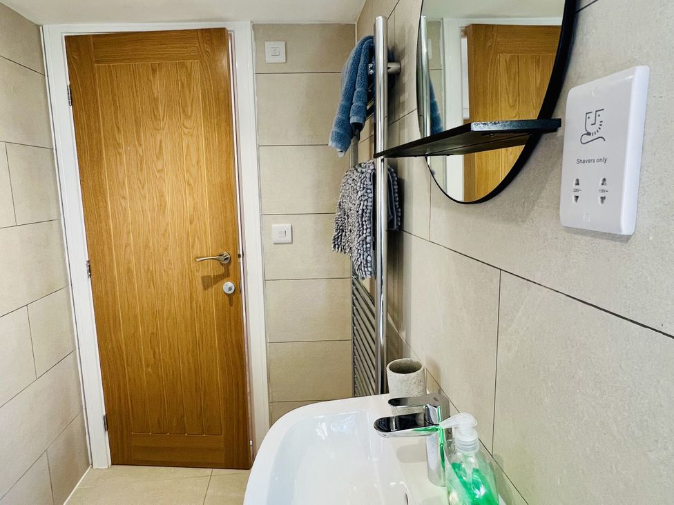 A bathroom with a sink and mirror at 2A Hamilton Road in Felixstowe