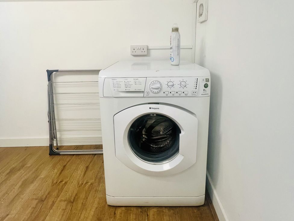 A washing machine with a drying rack and a water bottle at 2A Hamilton Road in Felixstowe