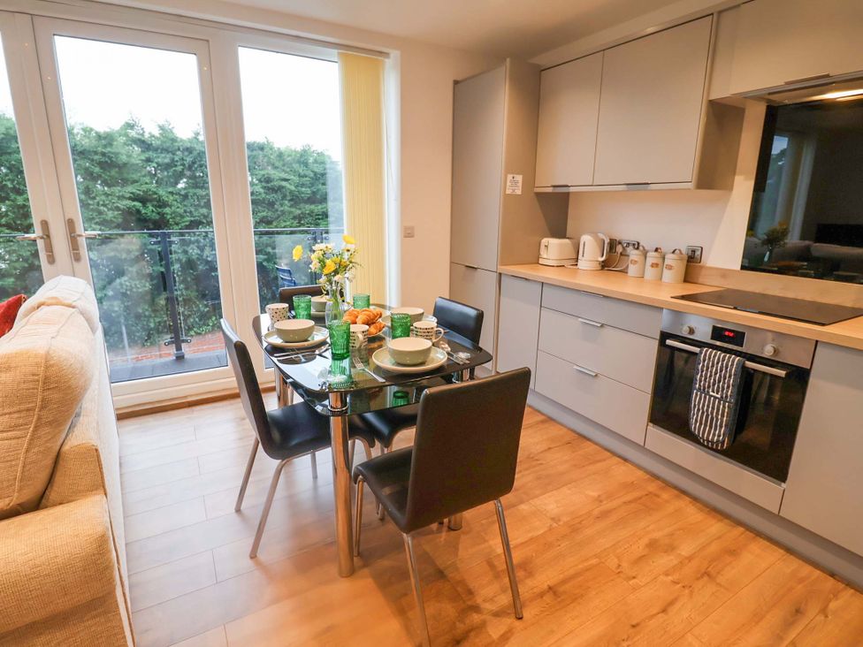 A kitchen with a dining table and chairs at Stylish Felixstowe Apartment with Fabulous Sea Views, Felixstowe, Suffolk