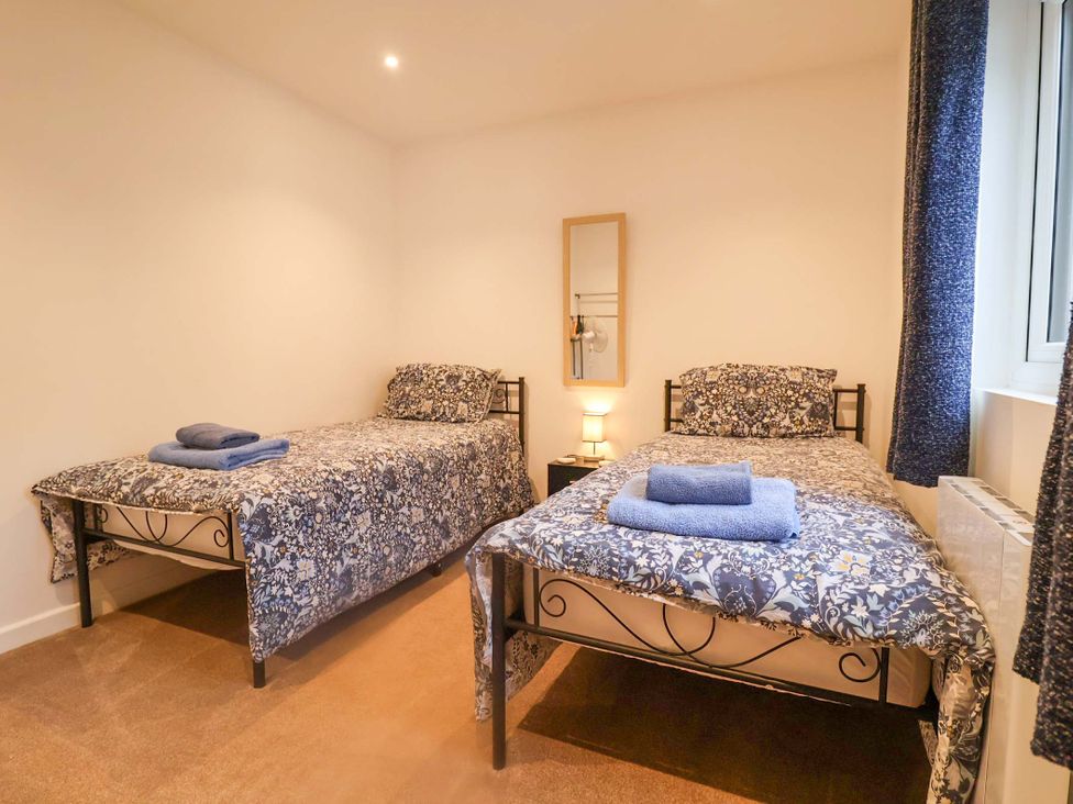 A bedroom with two beds and a lamp at Stylish Felixstowe Apartment with Fabulous Sea Views, Felixstowe, Suffolk