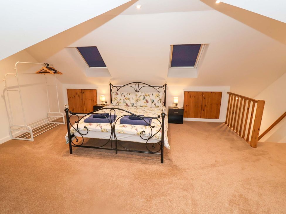 A bedroom with a bed and nightstand at Stylish Felixstowe Apartment with Fabulous Sea Views, Felixstowe, Suffolk