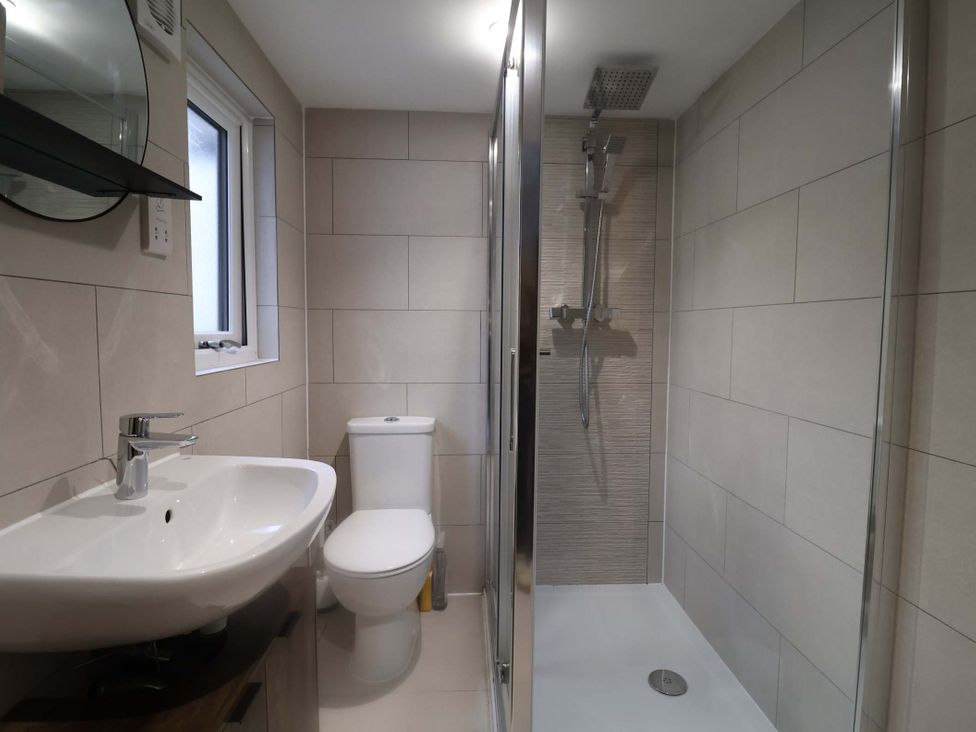 A bathroom with a sink, toilet, and shower in Stylish Felixstowe Apartment with Fabulous Sea Views, Felixstowe, Suffolk