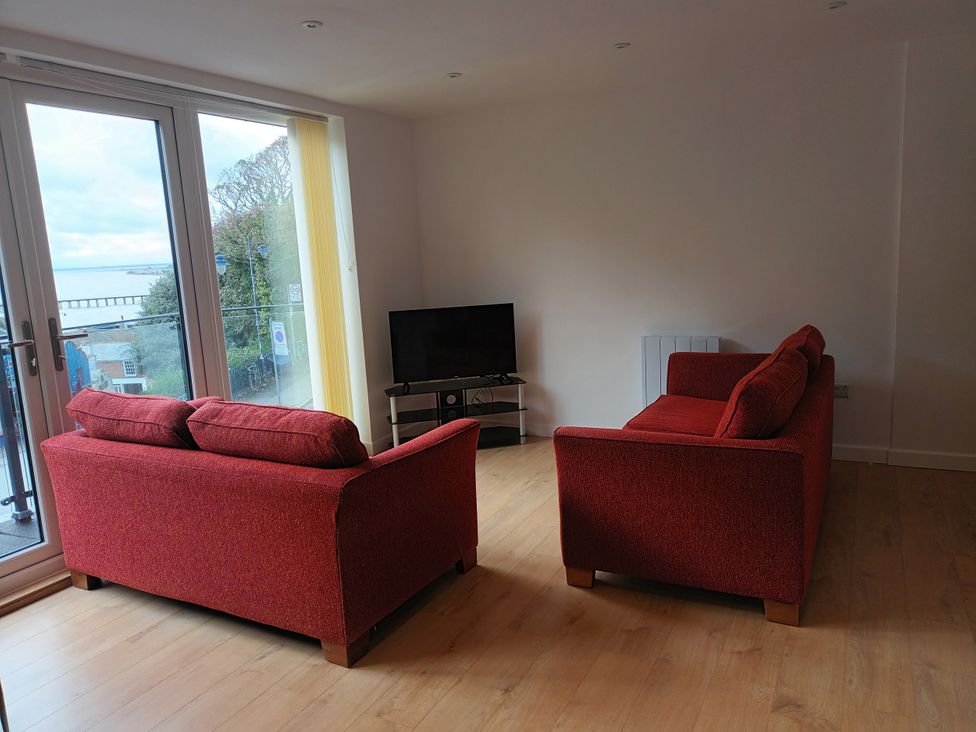 A living room with sofas and a television at 2B Hamilton Road in Felixstowe
