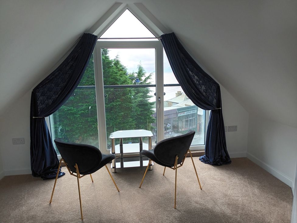 A snug with chairs and a table by a window at 2B Hamilton Road in Felixstowe