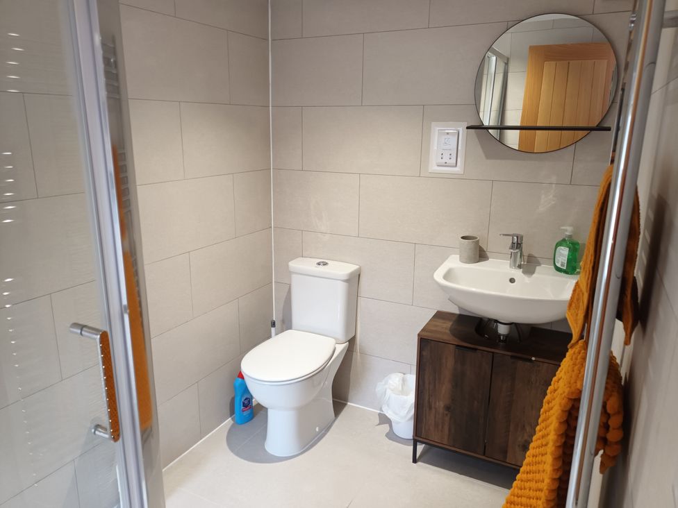 A bathroom with a sink, toilet, and shower at 2B Hamilton Road in Felixstowe