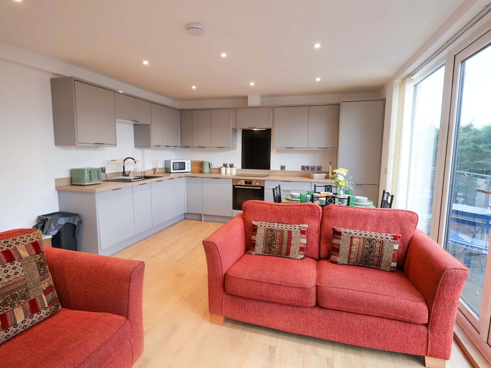 A kitchen with a sofa and dining table at 2B Hamilton Road in Felixstowe, Suffolk
