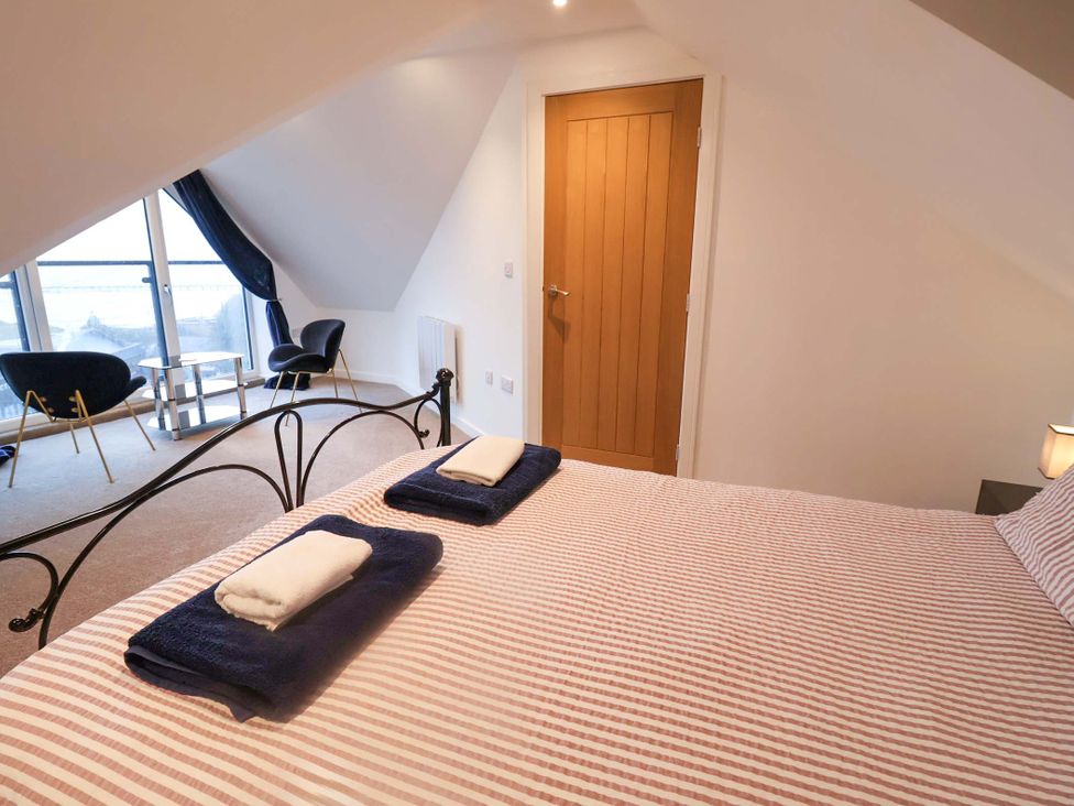 A bedroom with a bed and a chair at 2B Hamilton Road, Felixstowe, Suffolk