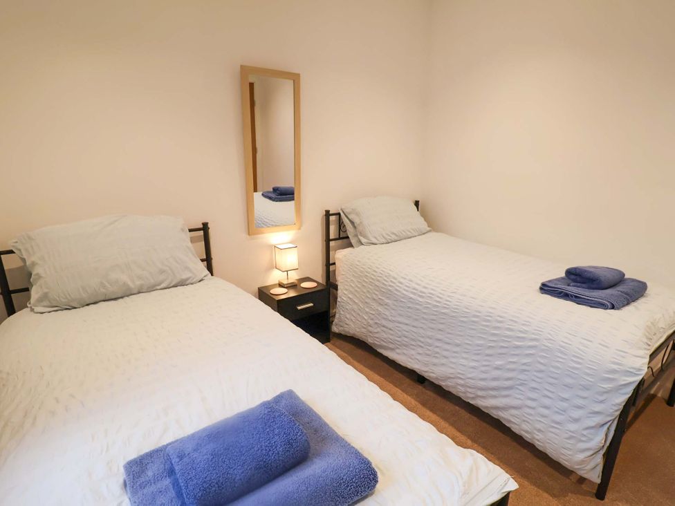 A bedroom with two beds and a lamp at 2B Hamilton Road, Felixstowe, Suffolk