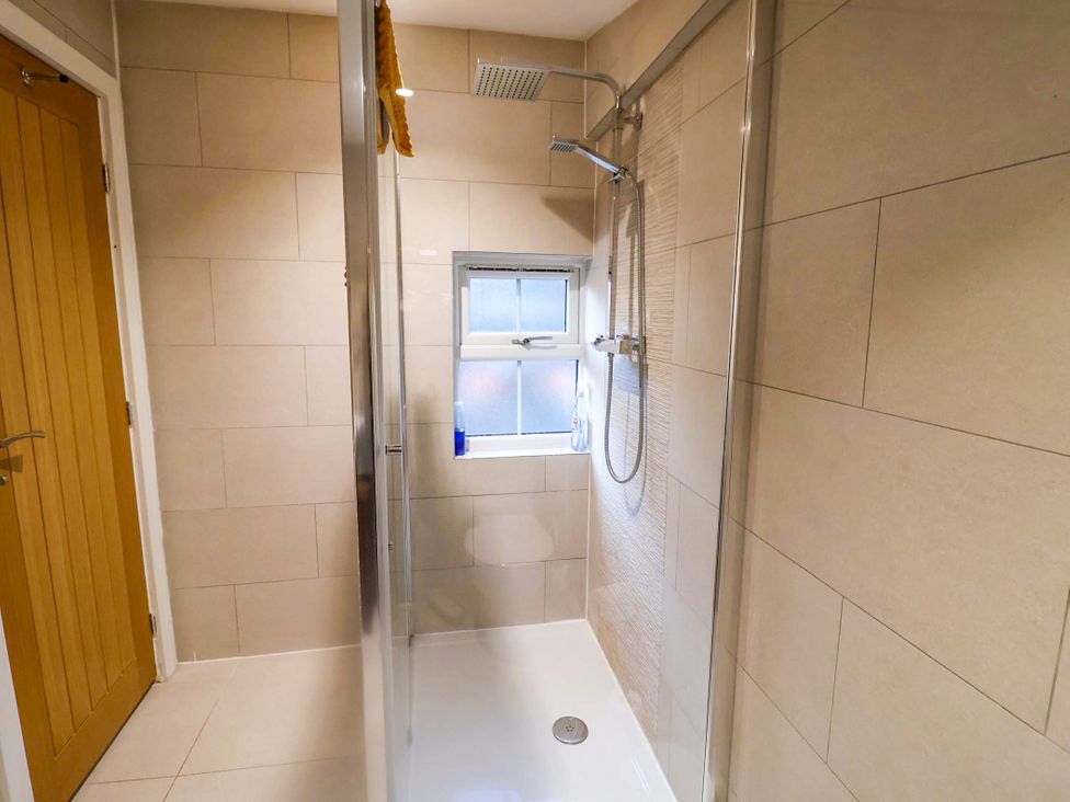 A bathroom with a shower and window at 2B Hamilton Road, Felixstowe, Suffolk