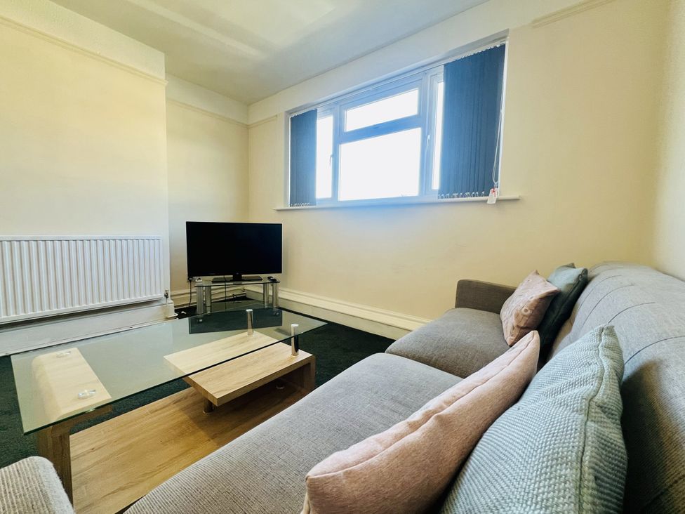 A living room with a sofa and television at 11 Langer Road, Felixstowe