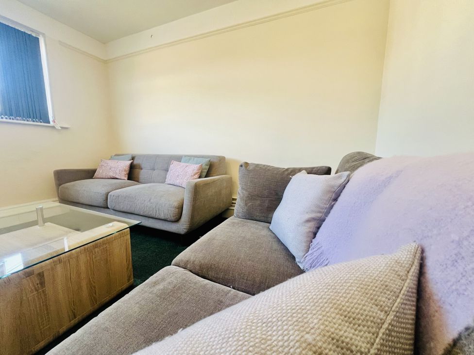 A living room with sofas and a coffee table at 11 Langer Road in Felixstowe