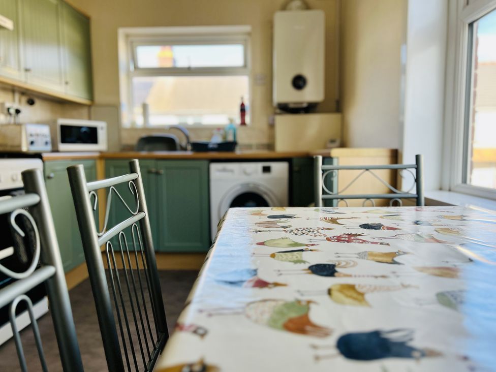 A kitchen with a table and chairs at 11 Langer Road in Felixstowe