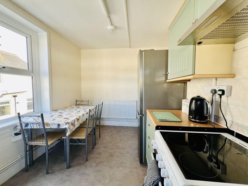 A kitchen with table and chairs at 11 Langer Road in Felixstowe