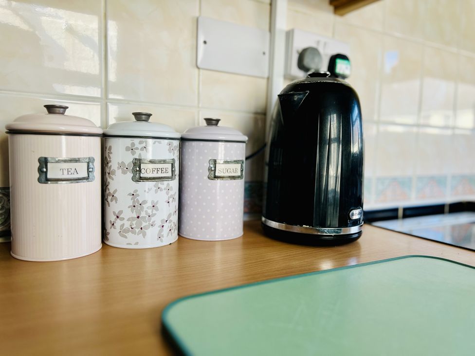 A kitchen countertop with canisters and a kettle at 11 Langer Road, Felixstowe