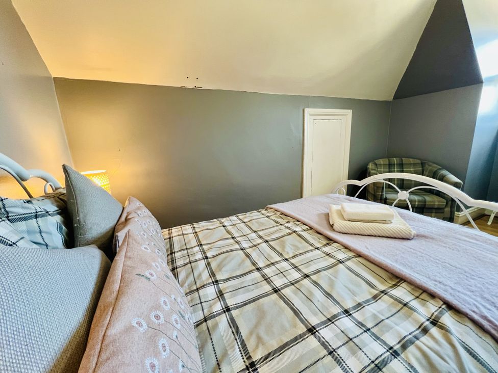 A bedroom with a bed and a chair at 11 Langer Road in Felixstowe