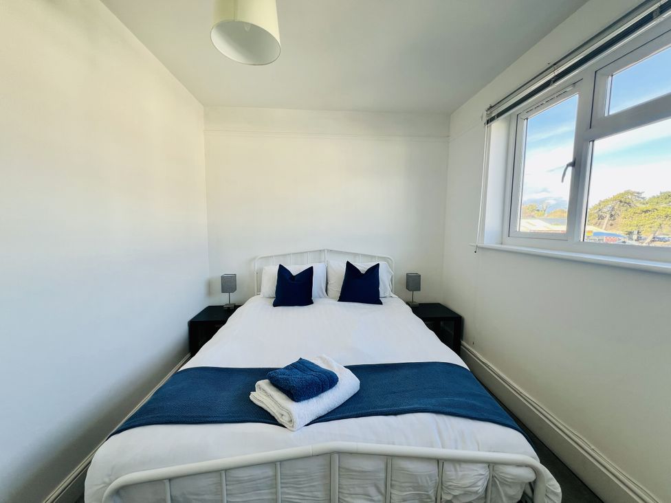 A bedroom with a bed and bedside tables at 11 Langer Road in Felixstowe