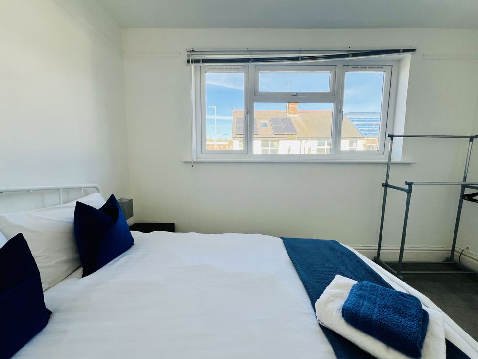 A bedroom with a bed and window at 11 Langer Road, Felixstowe